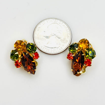 Colorful vintage rhinestone clip earrings shown with quarter for size.