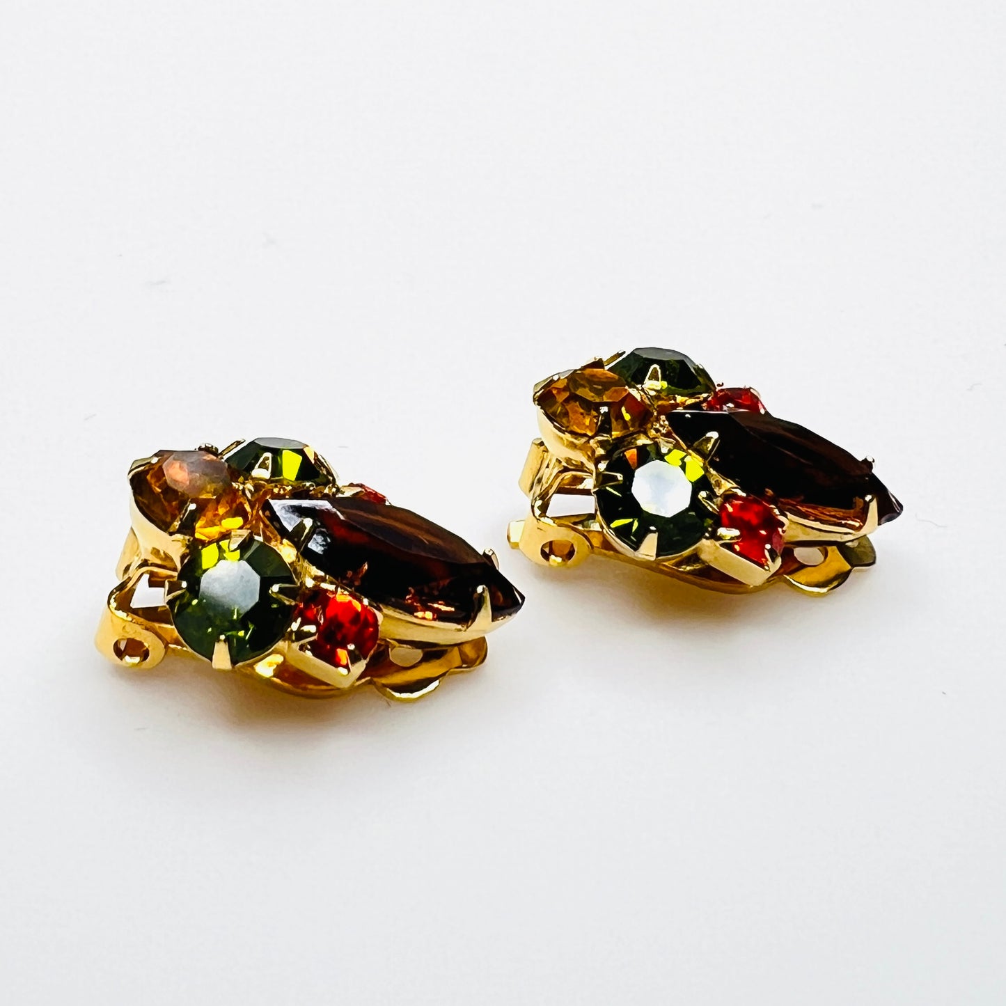 Side view of vintage gold-tone rhinestone clip-on earrings.
