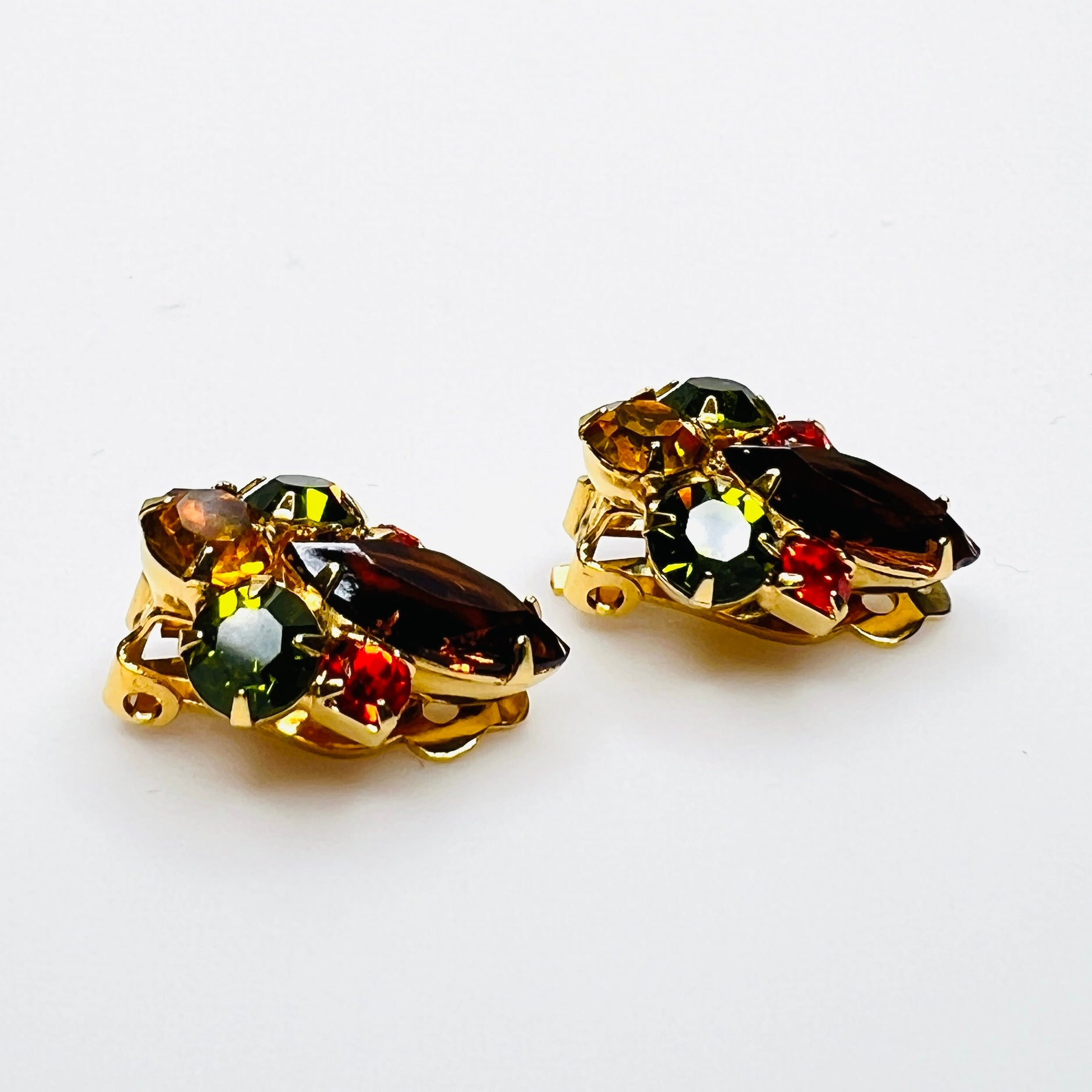 Side view of vintage gold-tone rhinestone clip-on earrings.