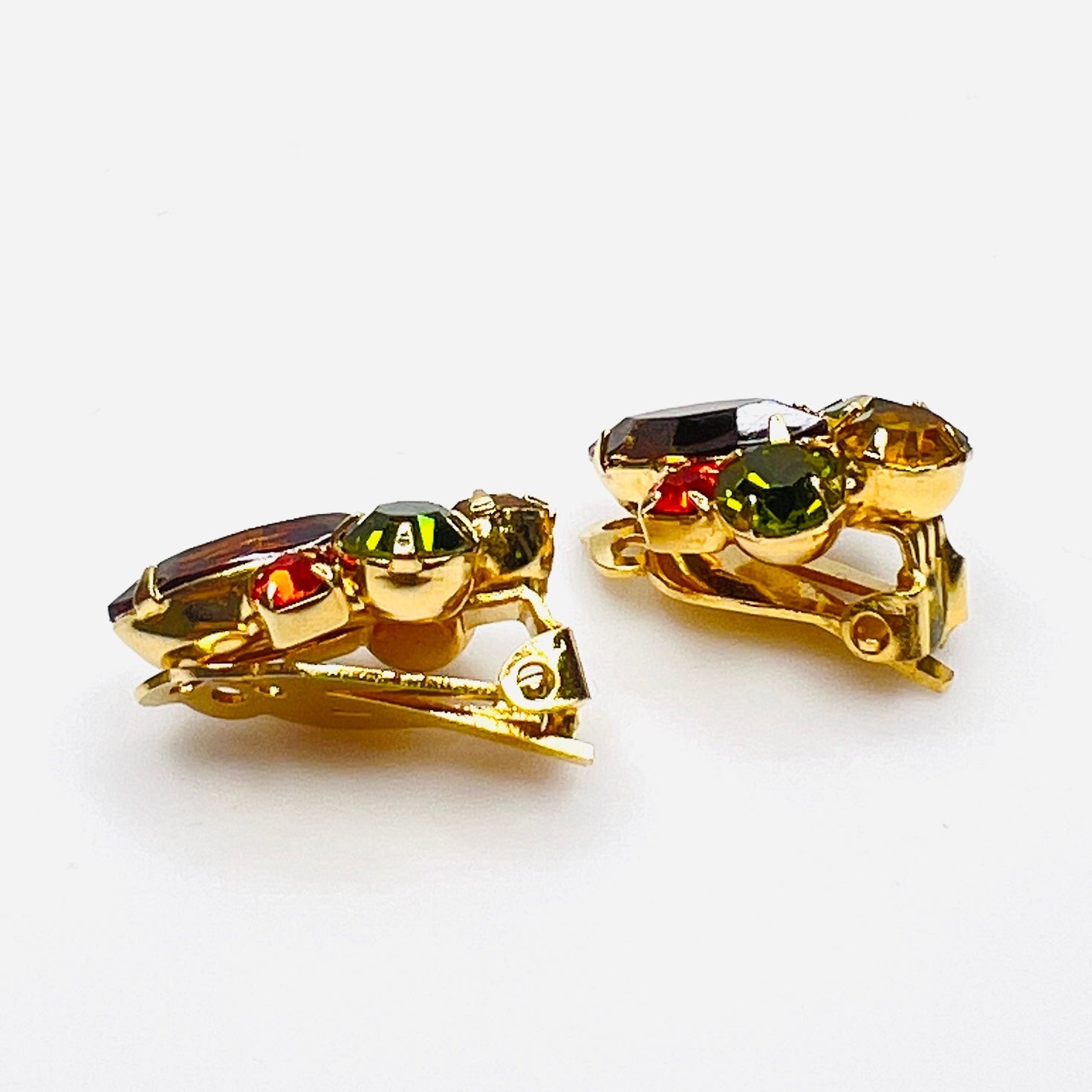 Side view of vintage gold-tone rhinestone clip-on earrings.