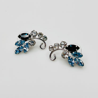 Vintage 1950s blue rhinestone floral stud earrings with silver tone setting