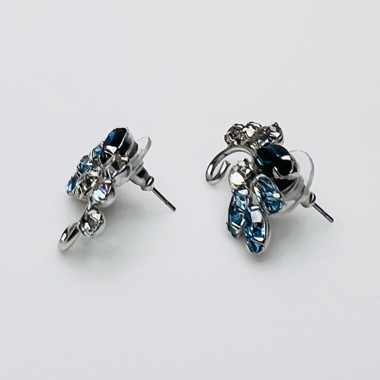 Side profile of vintage blue rhinestone spray earrings with marquise stones