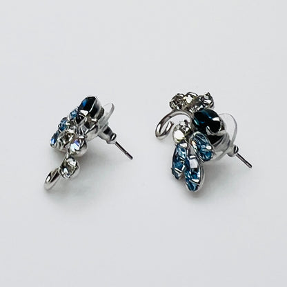 Side profile of vintage blue rhinestone spray earrings with marquise stones