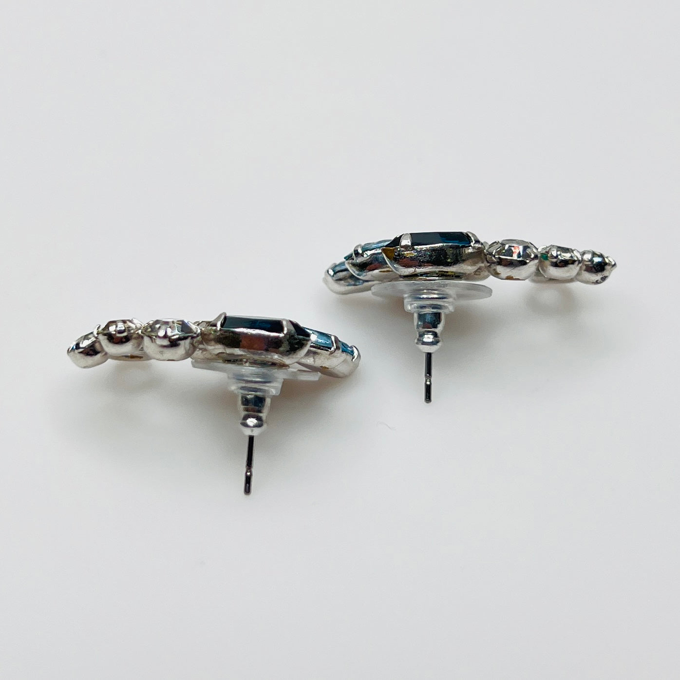 Side profile of vintage blue rhinestone spray earrings with marquise stones