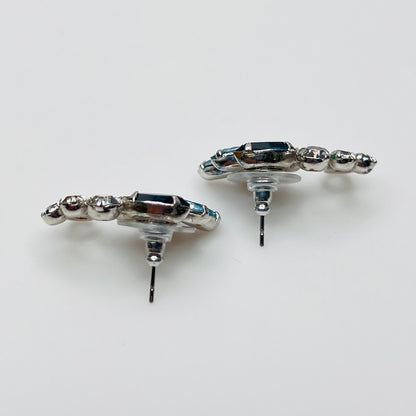 Side profile of vintage blue rhinestone spray earrings with marquise stones