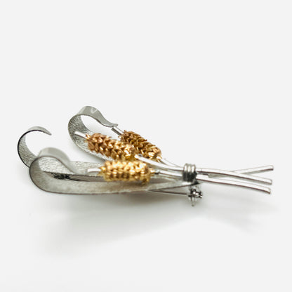 Side view of vintage two-tone cattail brooch showing dimensional metal construction