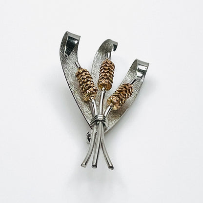 Side view of vintage two-tone cattail brooch showing dimensional metal construction