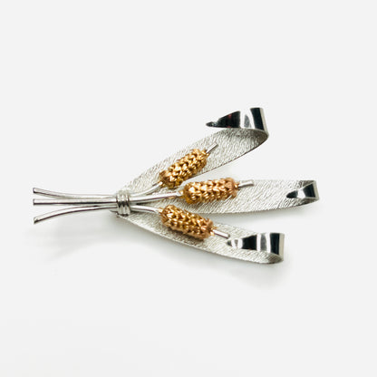 Side view of vintage two-tone cattail brooch showing dimensional metal construction