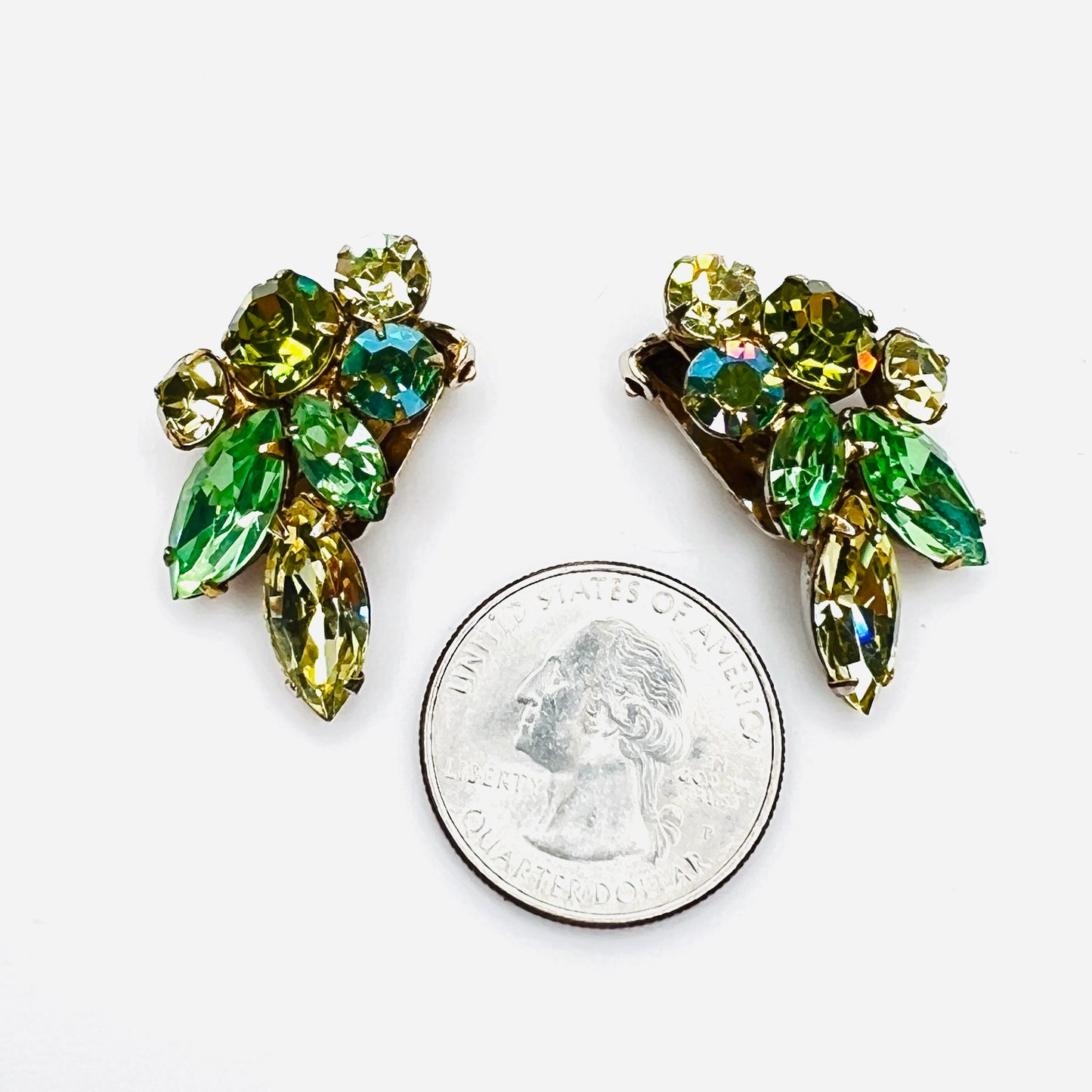 Green uranium glass rhinestone clip earrings shown beside quarter for scale.