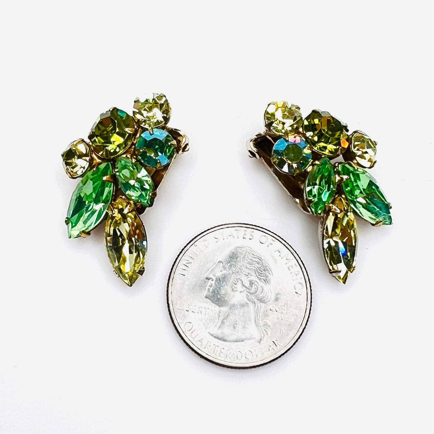 Green uranium glass rhinestone clip earrings shown beside quarter for scale.