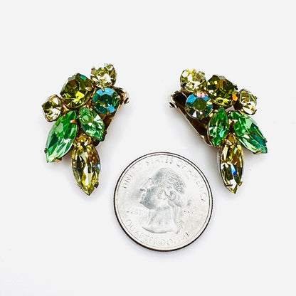 Green uranium glass rhinestone clip earrings shown beside quarter for scale.