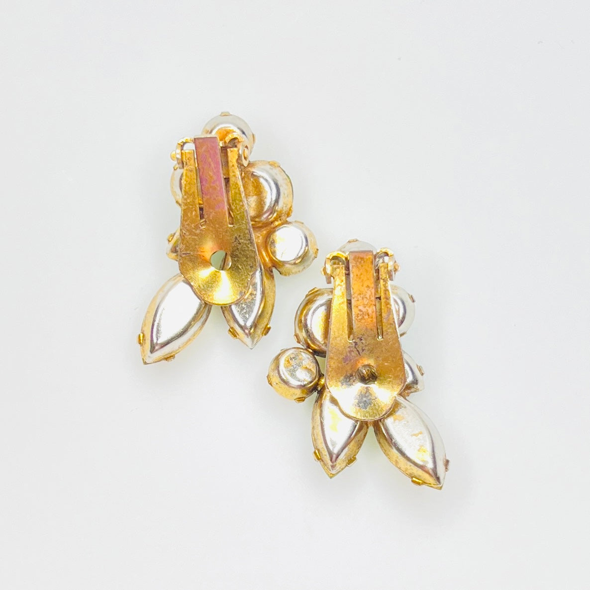 Back view of vintage gold tone clip-on earrings with secure clip closures.