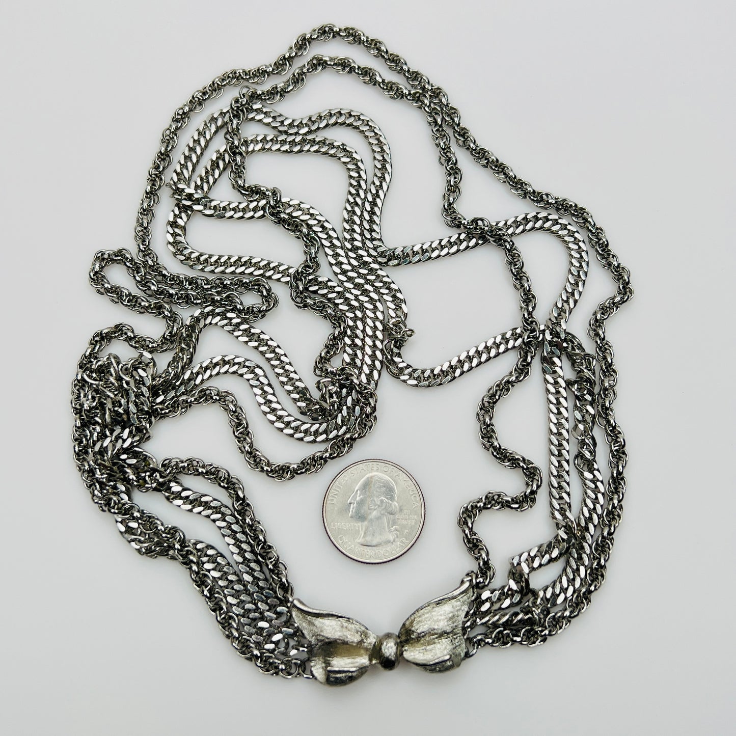 Multi chain necklace with bow clasp detail and mixed chain styles