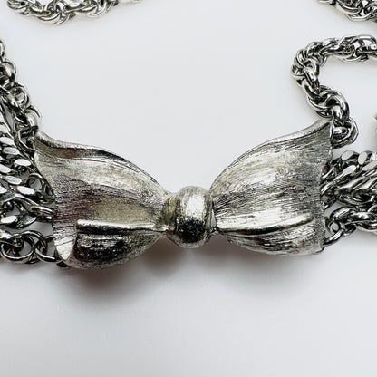 Close-up of brushed silver bow clasp on vintage necklace