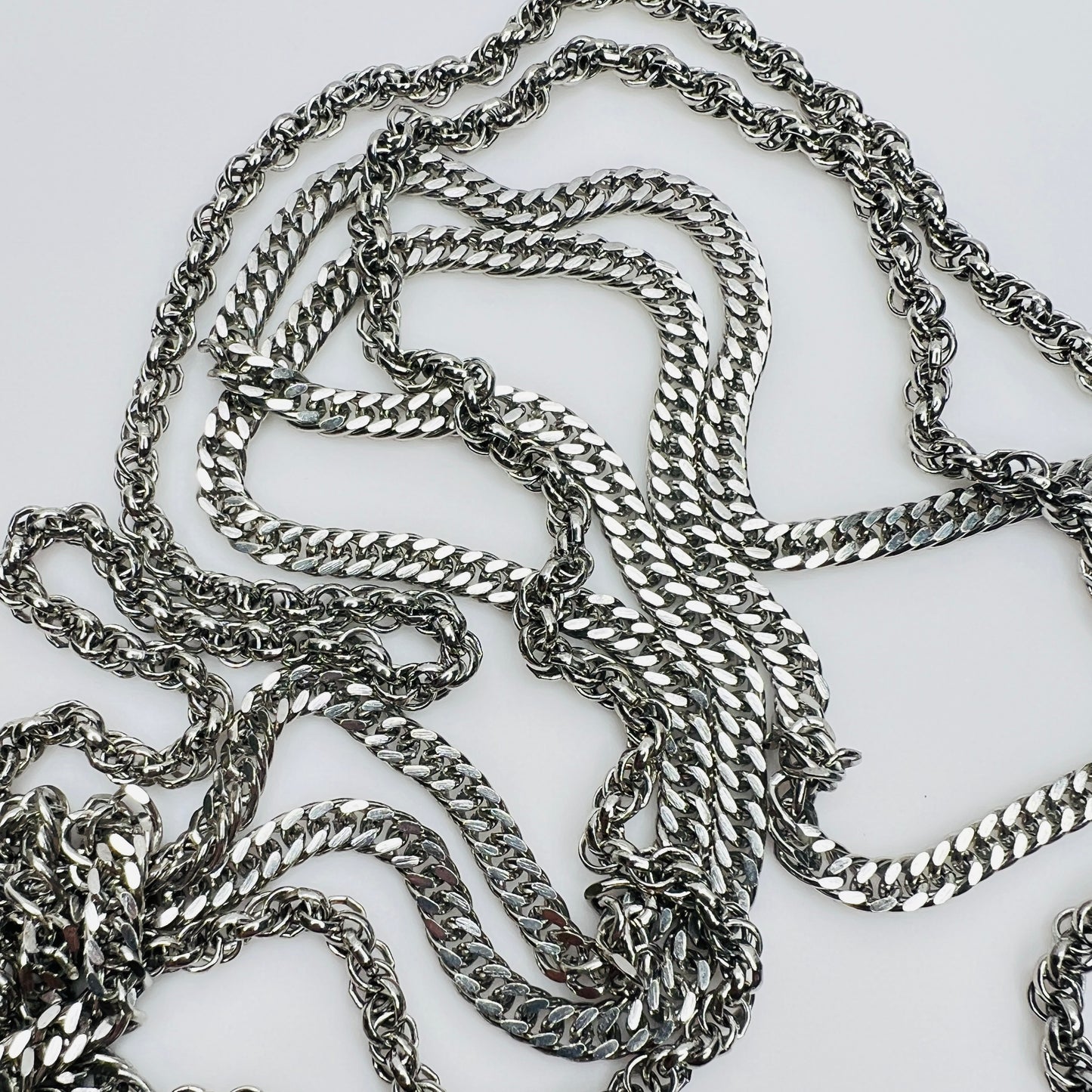 Multi chain necklace with bow clasp detail and mixed chain styles