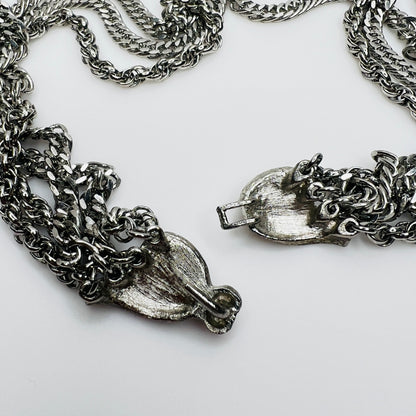 Close-up of brushed silver bow clasp on vintage necklace