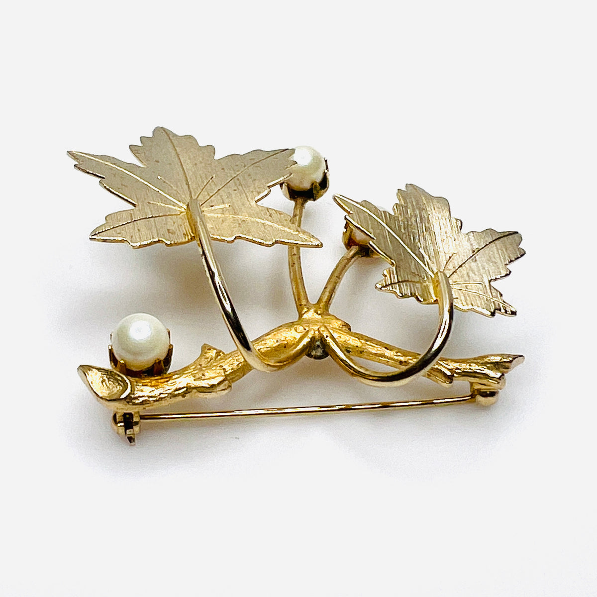 Reverse angle of Sarah Coventry maple leaf brooch showing textured leaves and dimensional construction