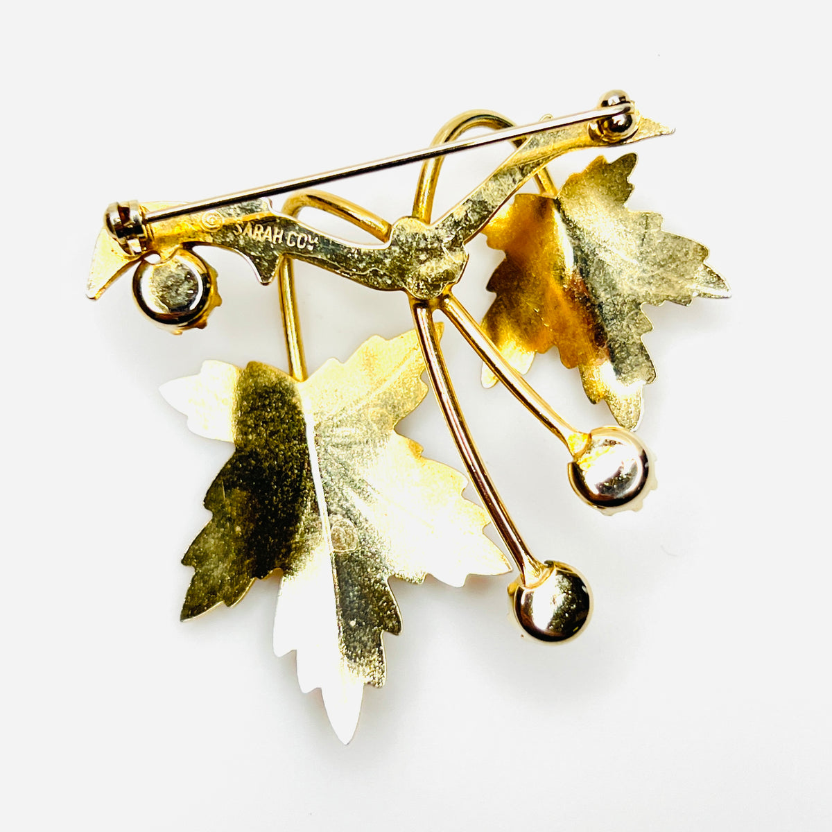 Back of vintage Sarah Coventry maple leaf brooch showing gold tone construction and pin closure