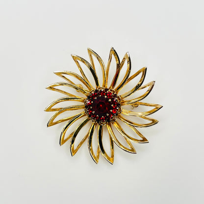 Vintage 1960s Sarah Coventry gold-tone flower brooch with ruby red rhinestone center