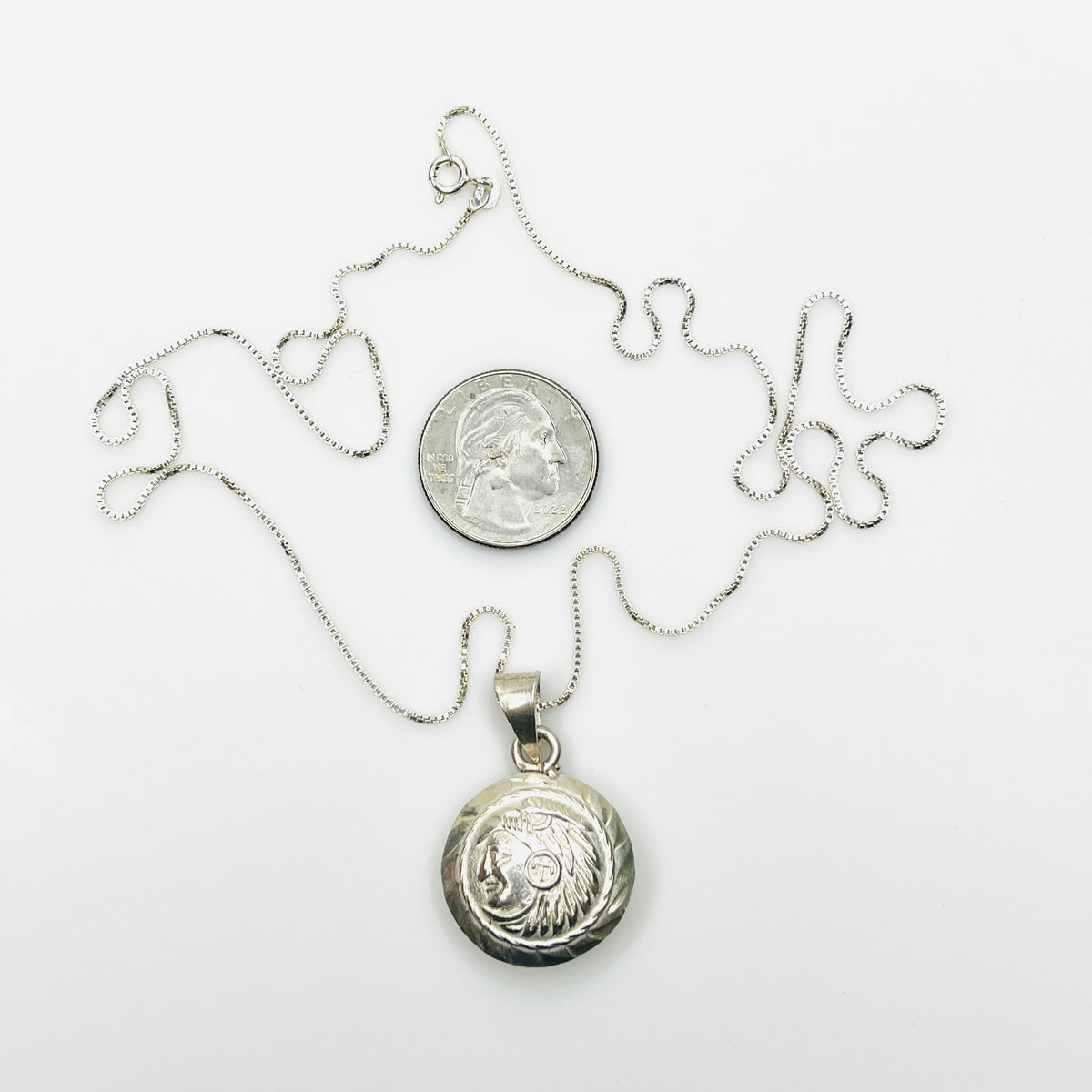 Vintage Aztec pendant necklace beside quarter showing scale and 24-inch box chain