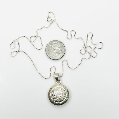 Vintage Aztec pendant necklace beside quarter showing scale and 24-inch box chain