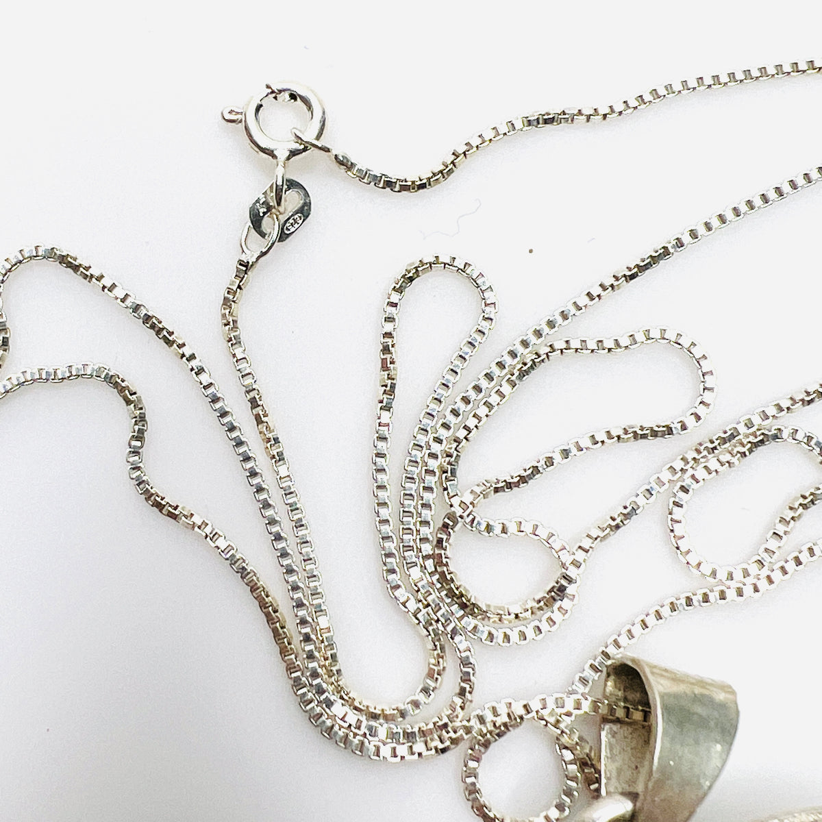 Close-up of 925 Italy box chain and spring ring clasp on Aztec pendant necklace