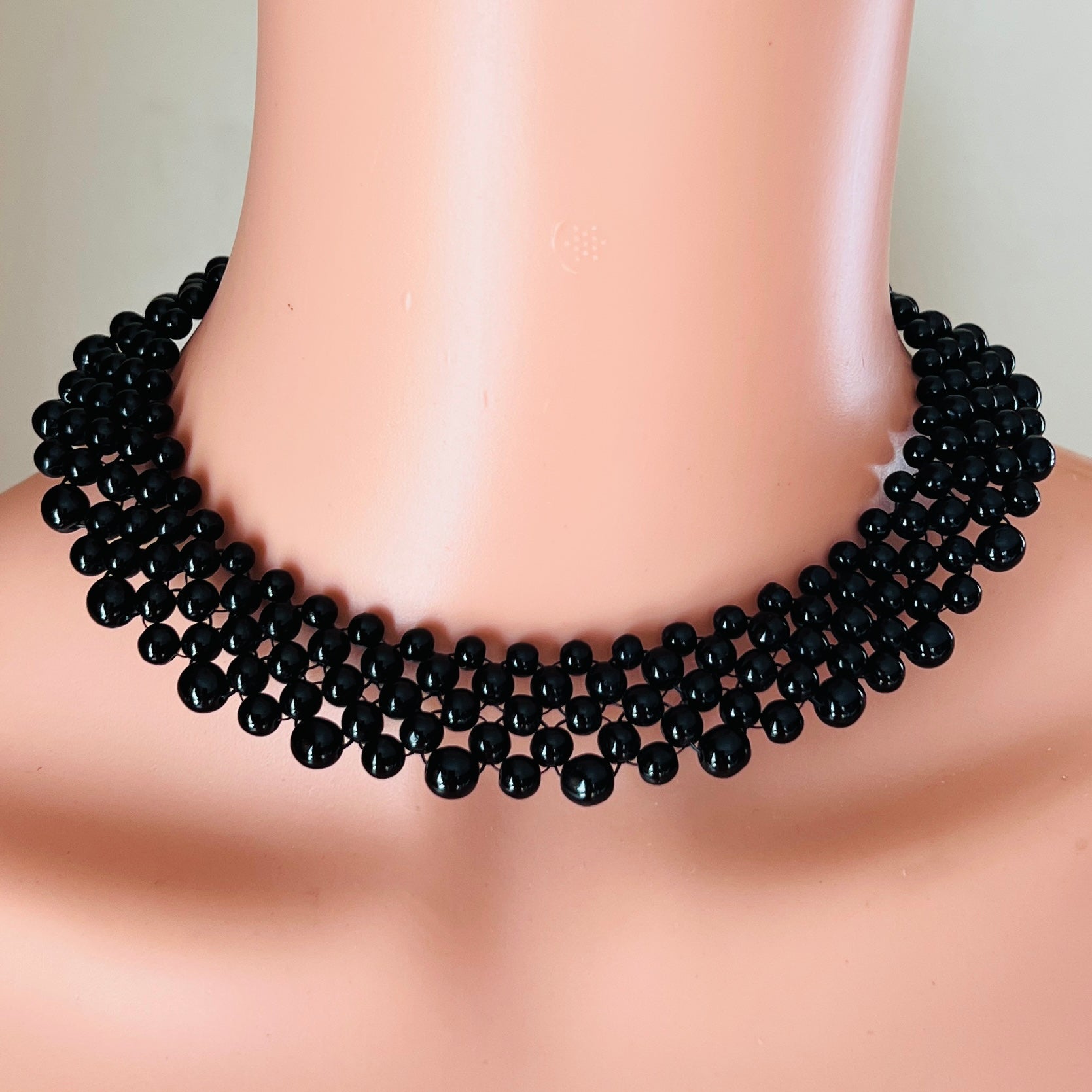 Vintage black glass bead collar necklace on mannequin