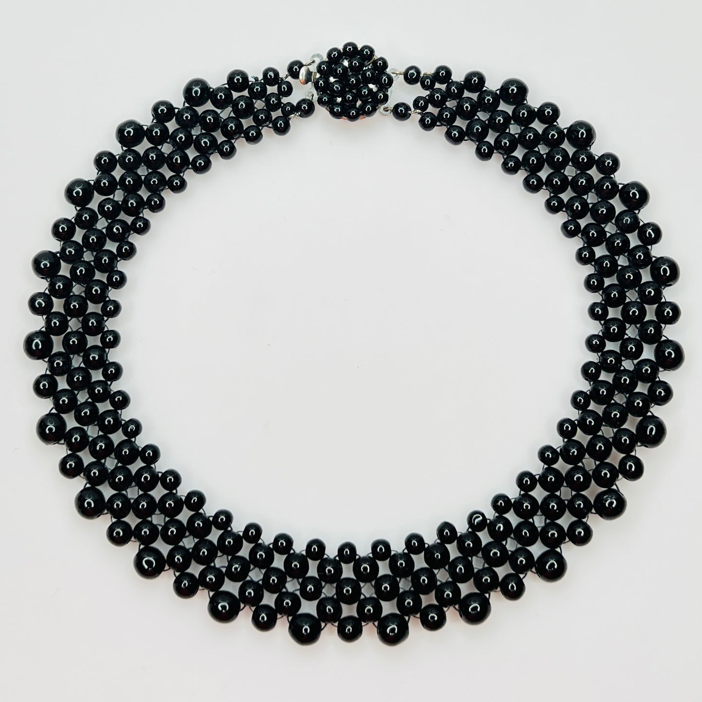 Top view of multi strand black beaded collar necklace