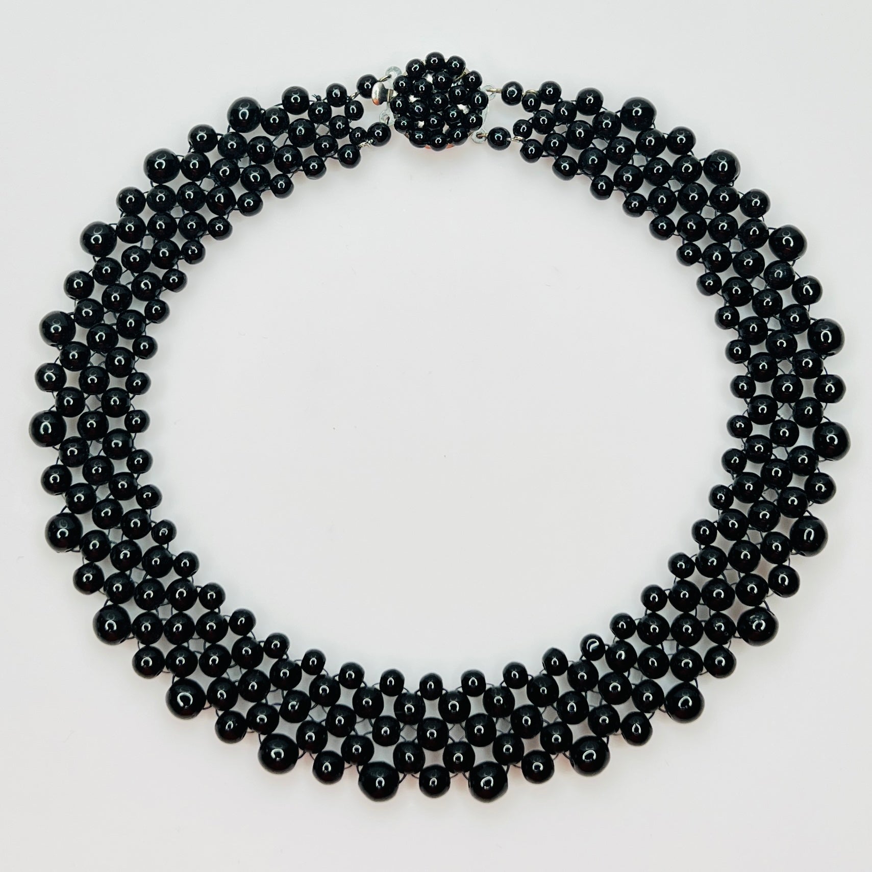 Top view of multi strand black beaded collar necklace