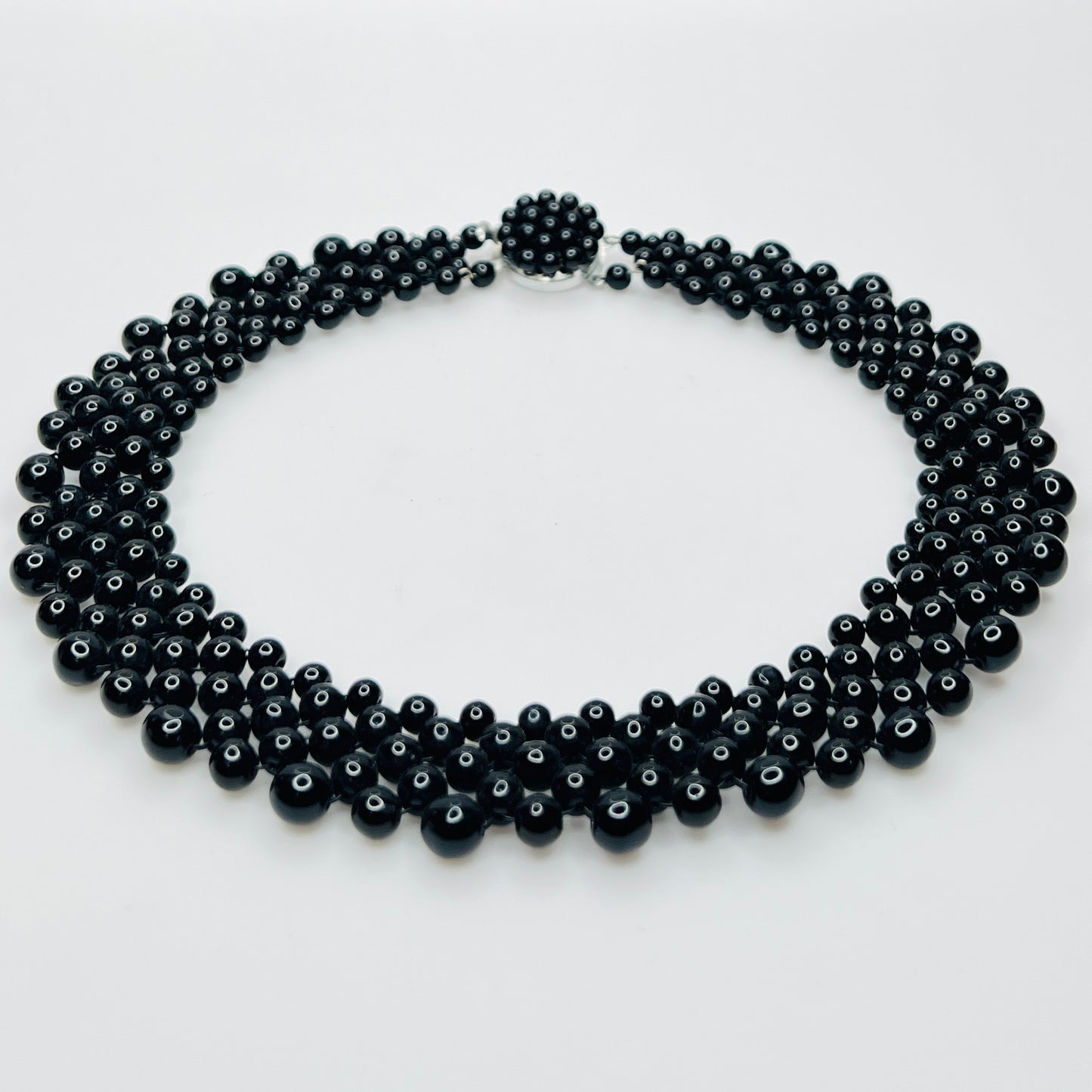 Top view of multi strand black beaded collar necklace