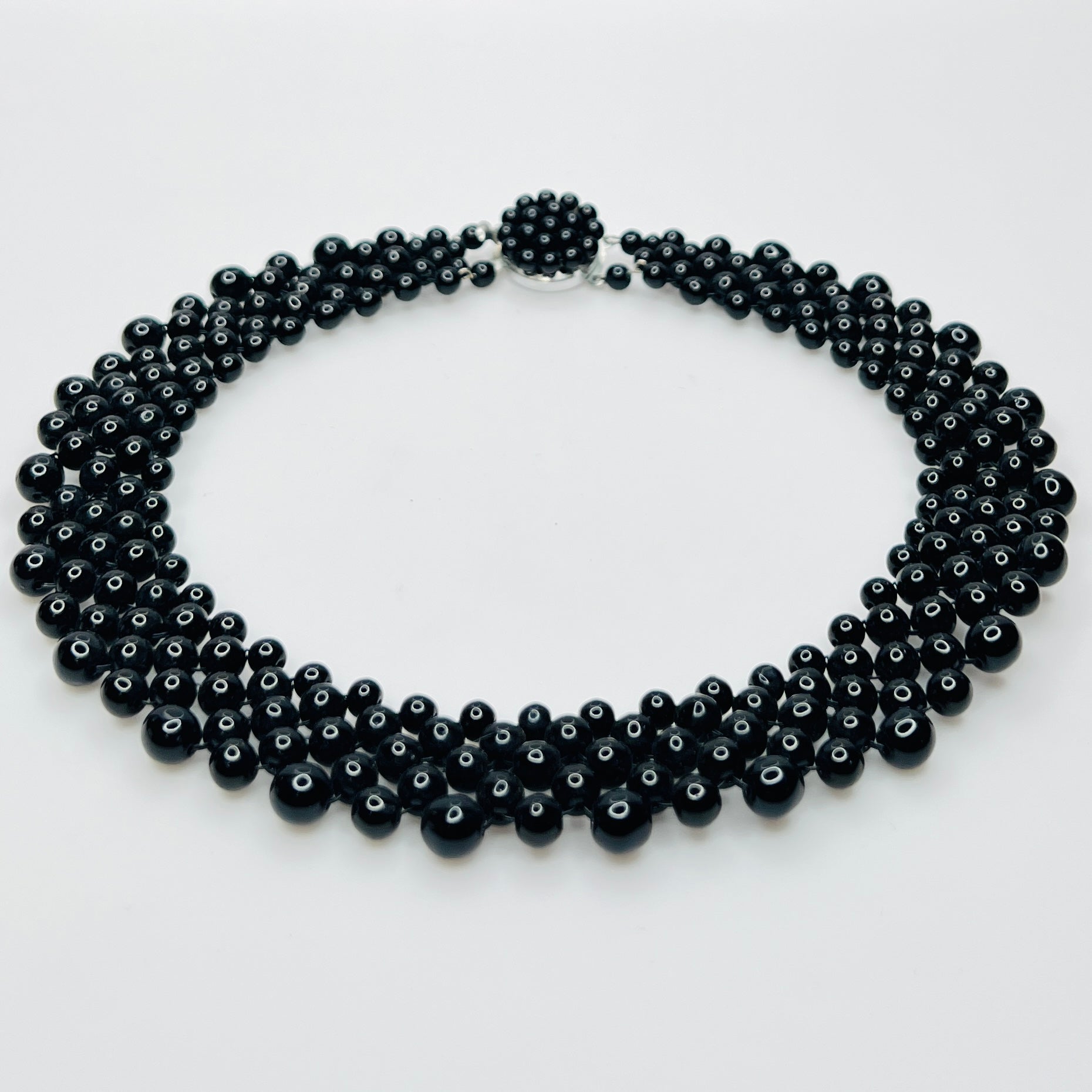 Top view of multi strand black beaded collar necklace