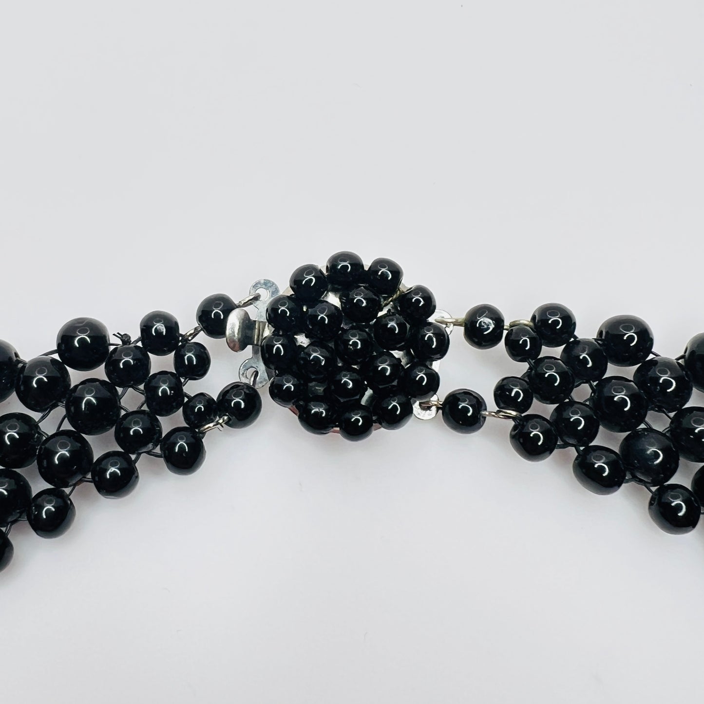 Close-up of box clasp on vintage black bead necklace