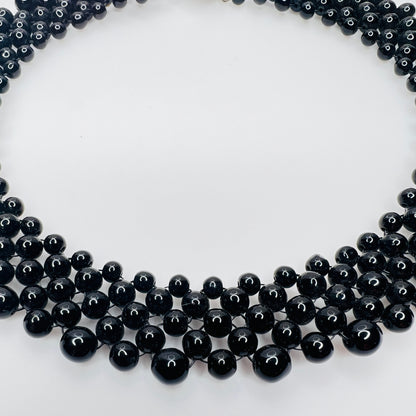 side view of multi strand black beaded collar necklace