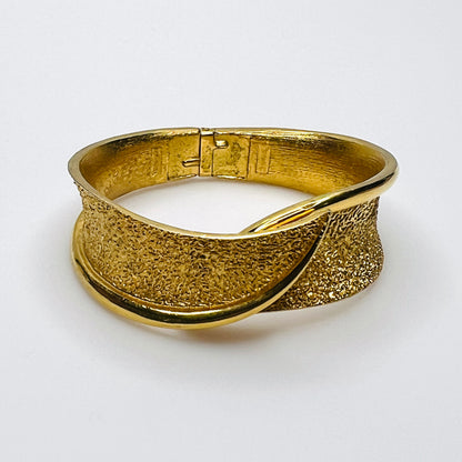 Vintage Crown Trifari gold tone hinged bypass clamper bracelet with textured finish