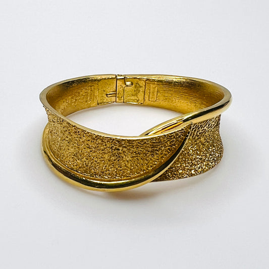 Vintage Crown Trifari gold tone hinged bypass clamper bracelet with textured finish