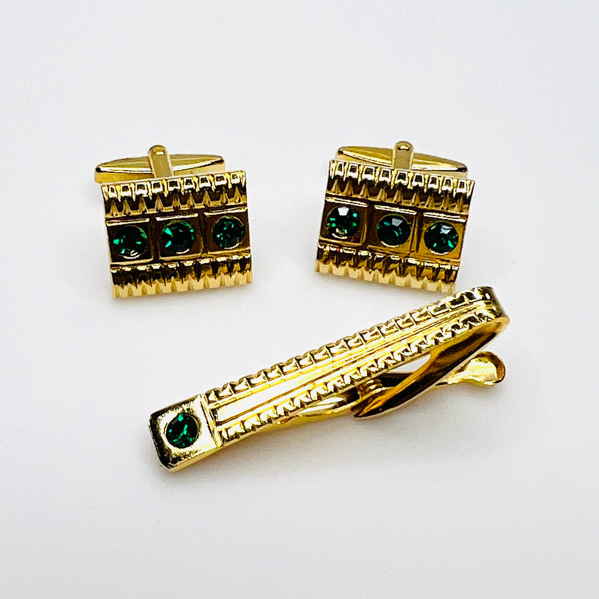 Vintage West Germany gold tone cufflink and tie clip set with emerald green glass rhinestones