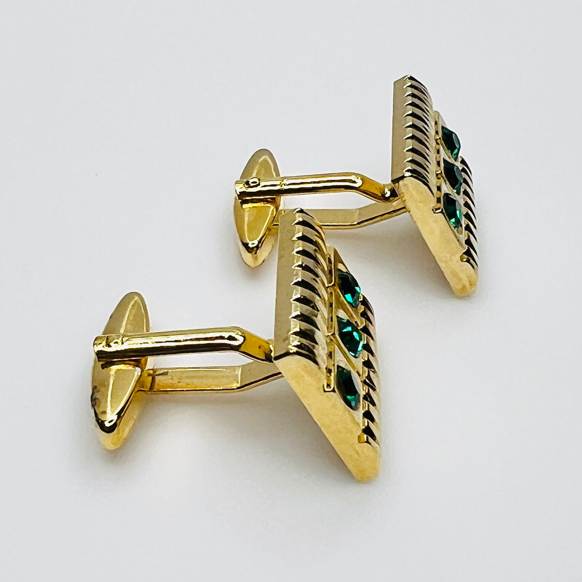 Side view of vintage West Germany rhinestone cufflinks showing swivel toggle closures