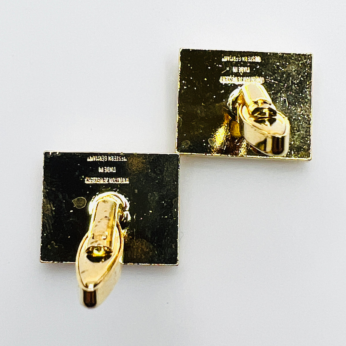 Reverse view of vintage West Germany rhinestone cufflinks showing swivel toggle closures