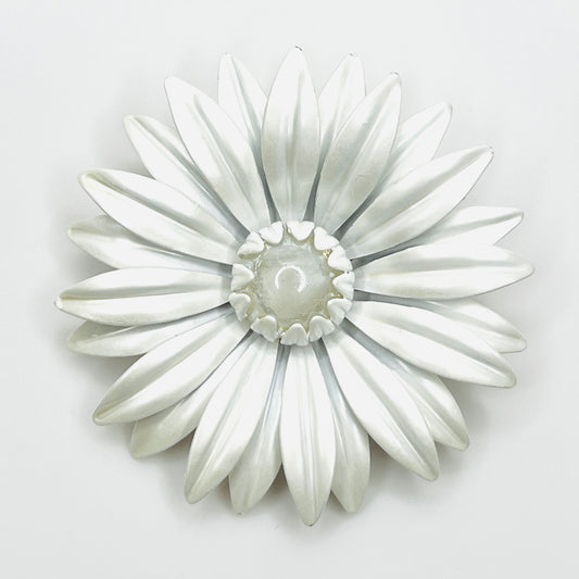 Large vintage white enamel daisy brooch with layered pointed petals and a clear domed Lucite center.