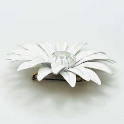 Side view of white enamel daisy brooch showing curved layered petals, Lucite center, and tiny enamel chips.