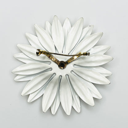 Reverse of unsigned white enamel daisy brooch showing petal construction and aged metal pin assembly.