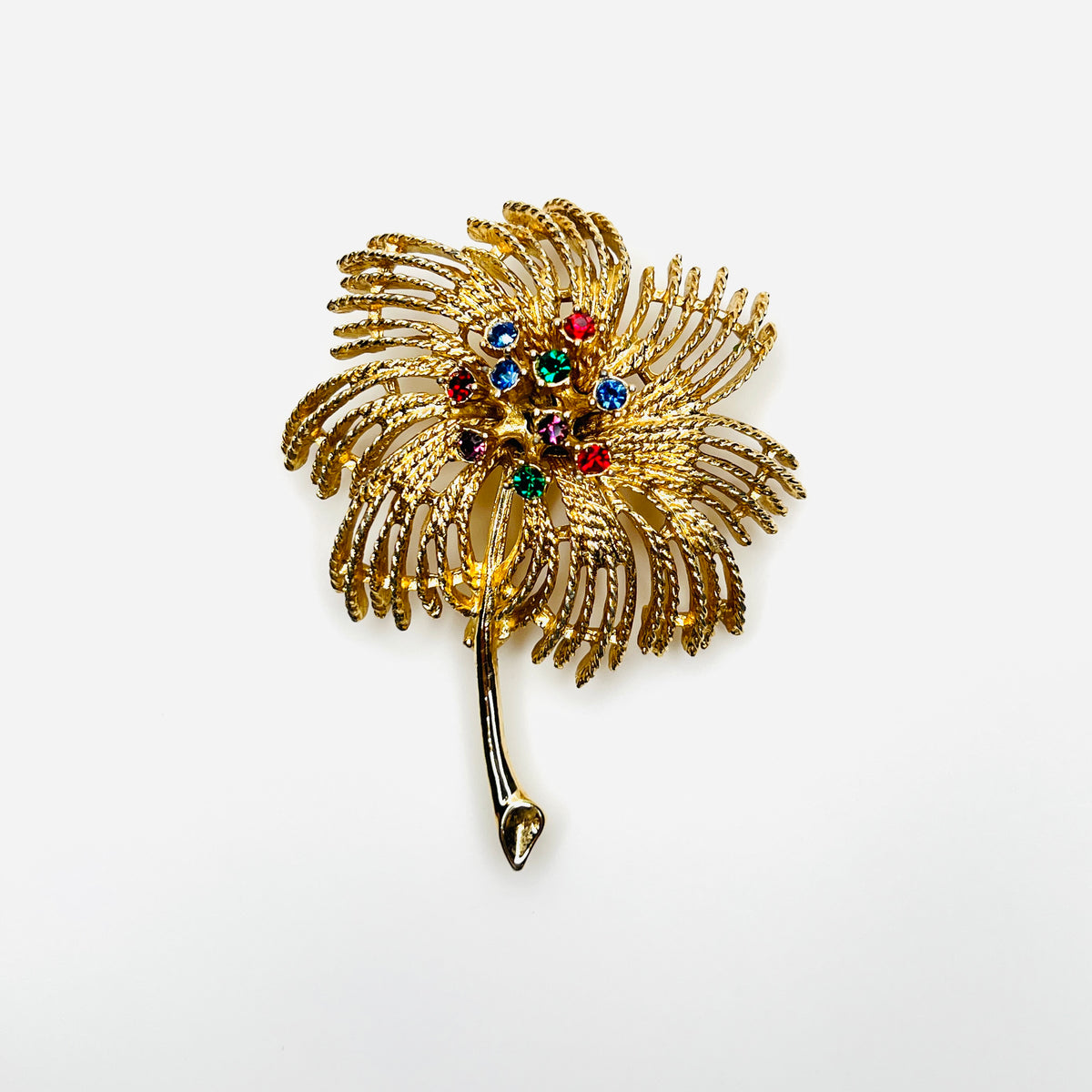 Vintage 1960s Sarah Coventry gold-tone palm spray brooch with multicolored rhinestones