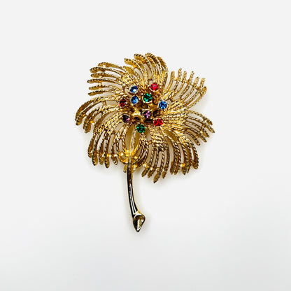 Vintage 1960s Sarah Coventry gold-tone palm spray brooch with multicolored rhinestones