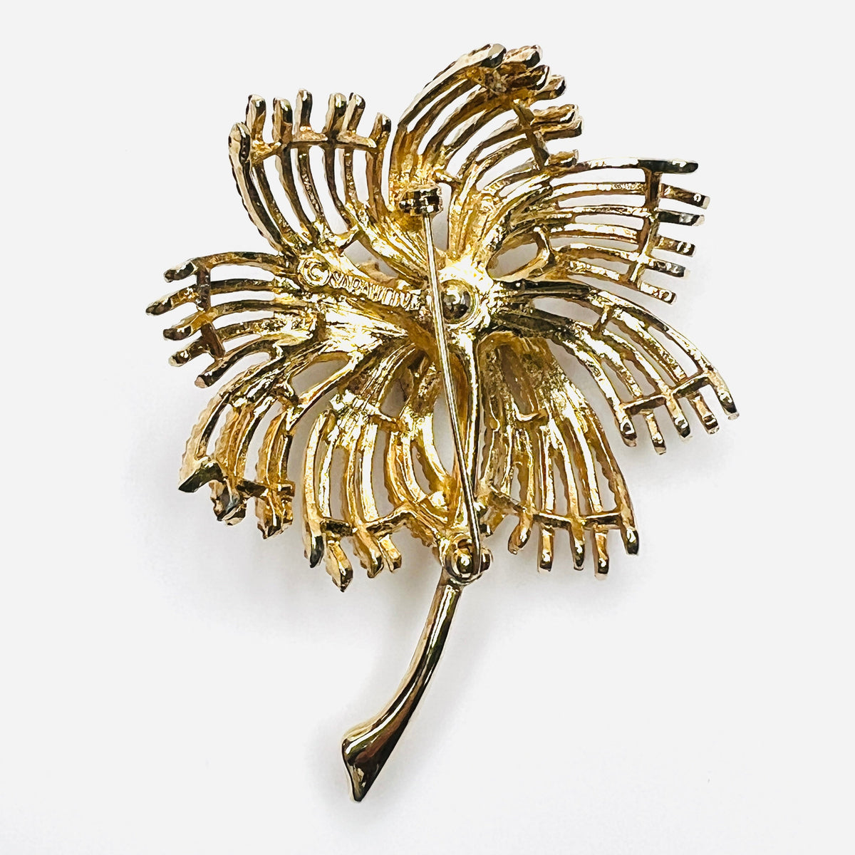 Reverse of signed Sarah Coventry gold-tone palm spray brooch with pin closure