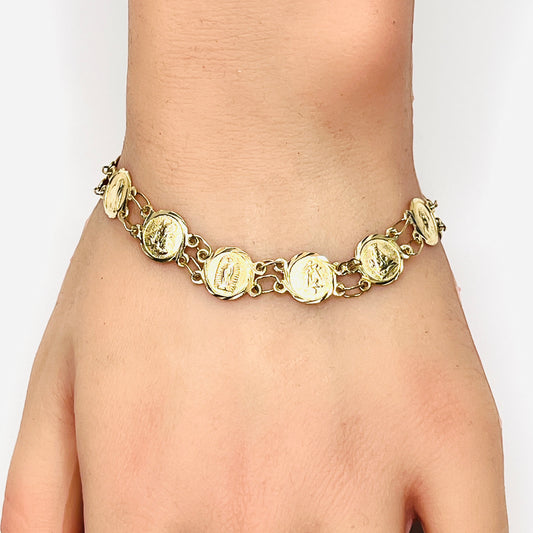 Vintage 14K gold Catholic saints medal bracelet shown worn on wrist