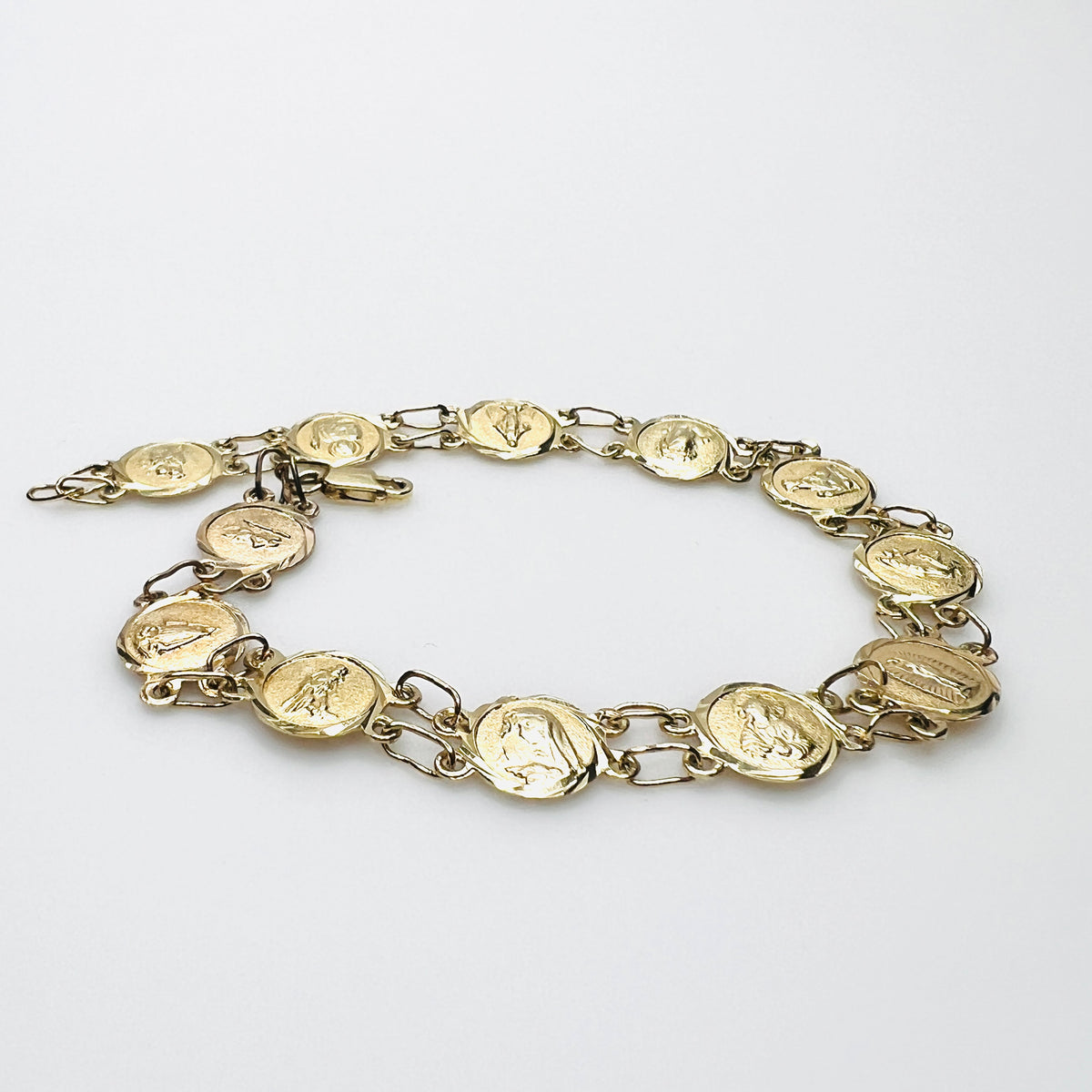 Side view of vintage 14K gold Catholic medal bracelet with double link construction