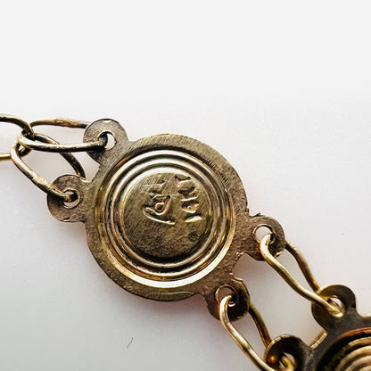 Close-up of maker's mark on vintage 14K gold Catholic medal bracelet