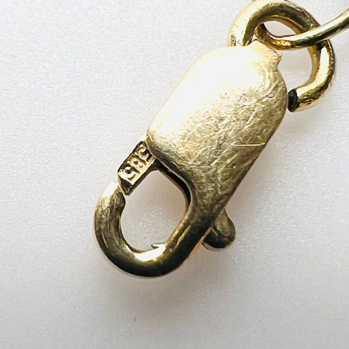 Vintage 14K gold bracelet lobster clasp showing European 585 gold hallmark