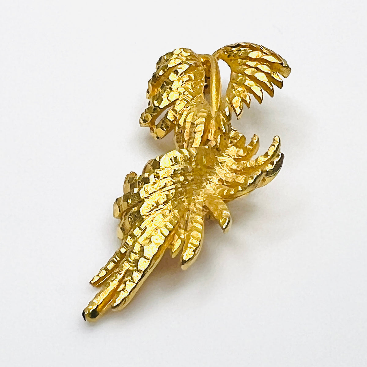 Side profile of vintage BSK botanical brooch showing dimensional textured gold-tone metal foliage