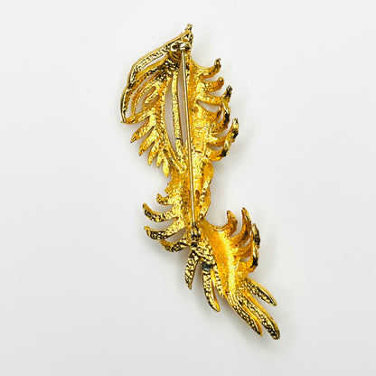 Reverse of vintage BSK gold-tone leaf spray brooch showing pin clasp and textured metal construction